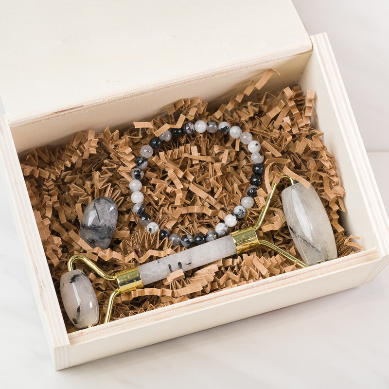 Black Tourmaline and quartz face massage roller set from Sacred Light Soundbaths and Crystals, designed for soothing skincare.