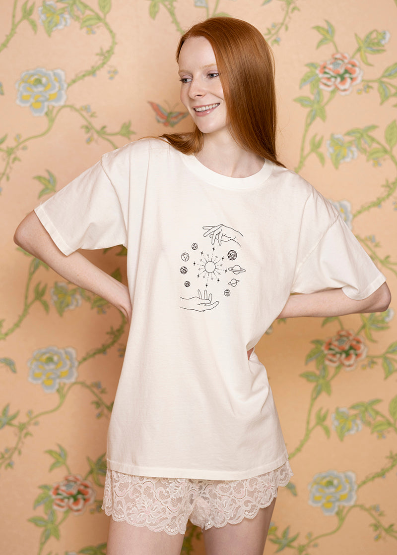 Sacred Light Soundbaths and Crystals celestial oversized T-shirt with cosmic print and relaxed fit, displayed on a plain background.