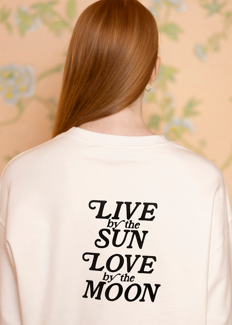Sacred Light Soundbaths and Crystals "Live by the Sun, Love by the Moon" crewneck sweatshirt with celestial design.