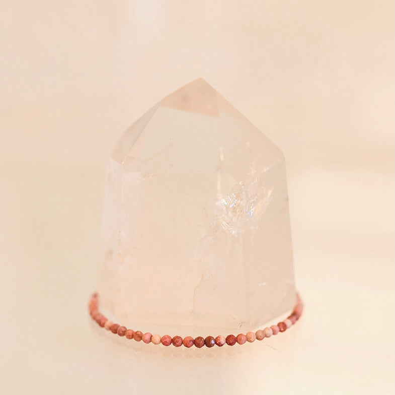 Dainty Grade AAA Rhodonite bracelet by Milk and Honey featuring polished pink and black gemstone beads on a delicate chain.