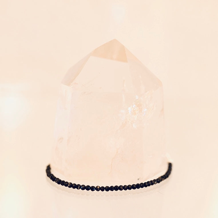 Dainty black tourmaline bracelet by Milk and Honey featuring small polished stones on a delicate jewelry chain.