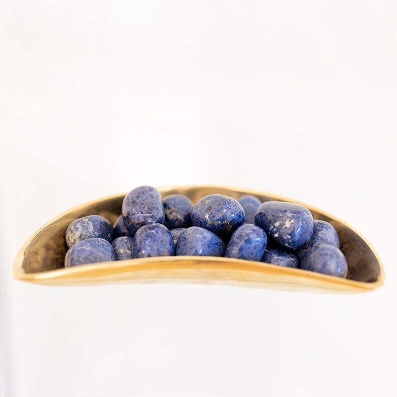 Tumbled Peruvian Dumortierite stone from Sacred Light Soundbaths and Crystals, showcasing its deep blue and unique mineral texture.