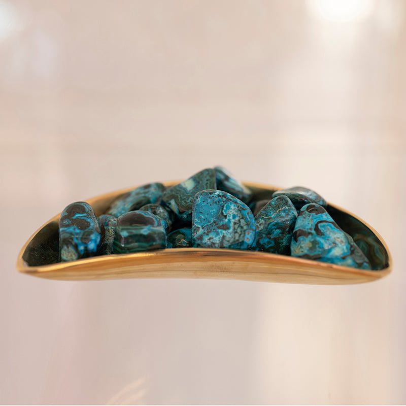 Close-up of tumbled Malacholla stones combining vibrant green Malachite and blue Chrysocolla, showcasing their smooth, polished surfaces.