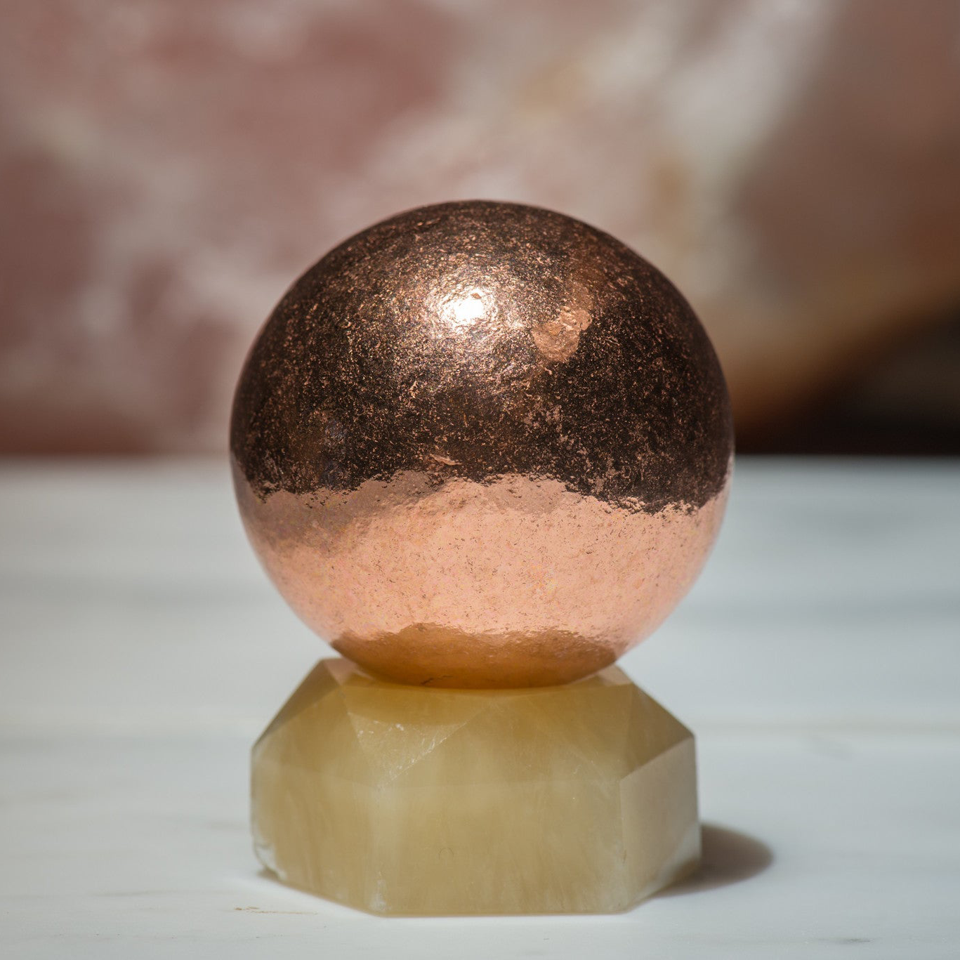 Small copper sphere made of stones from Sacred Light Soundbaths and Crystals, shown in a clear close-up image.