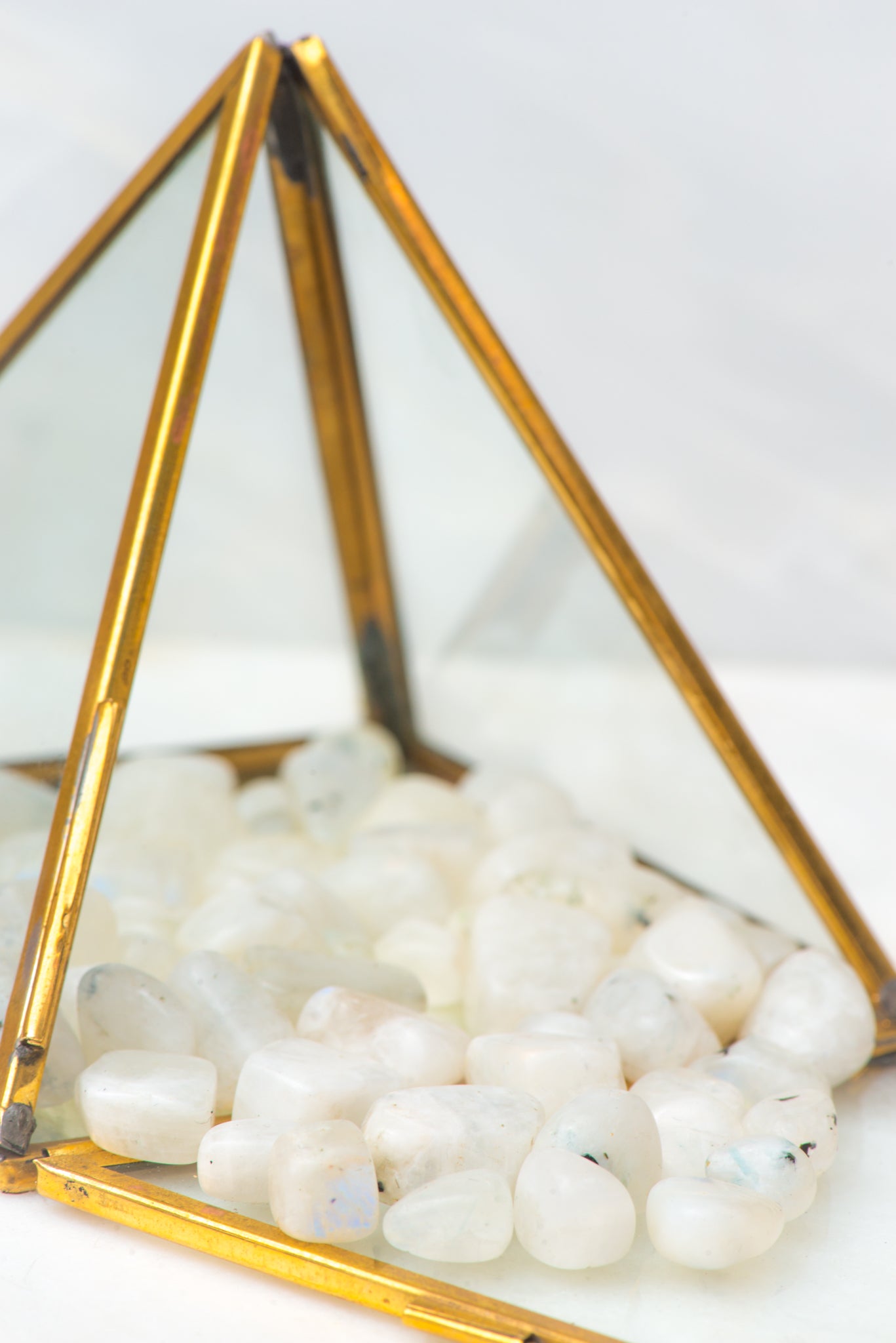 Tumbled rainbow moonstone crystal stone from Sacred Light Soundbaths and Crystals, showcasing its iridescent rainbow hues and smooth surface.