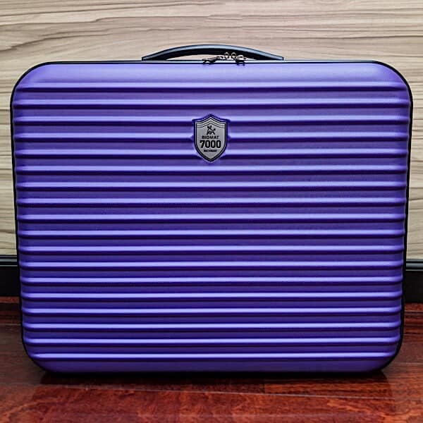 Mini Biomat® 7000MX in protective case, portable infrared therapy mat by Biomat, with soft fabric cover and control panel.