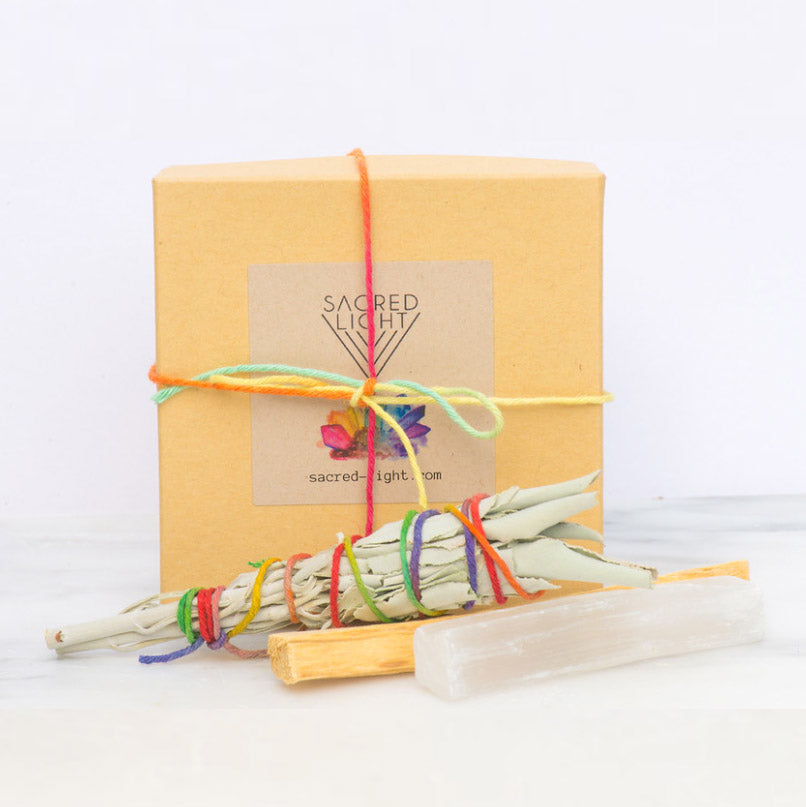 Sacred Light Soundbaths and Crystals space clearing gem set, featuring various crystals and tools for energetic cleansing.